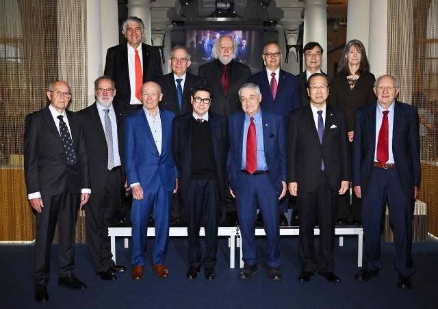 The 2025 Nobel Laureates pose for a group photo before the signing of the Nobel Chairs at the Nobel Museum in Stockholm, Sweden, December 6, 2025: (top row, LtoR) John M Martinis (Physics), Michel H Devoret (Physics), László Krasznahorkai (Literature), Omar M Yaghi (Chemistry), Shimon Sakaguchi (Medicine), Mary . Brunkow (Medicine), (bottom row, LtoR) Richard Robson (Chemistry), Fred Ramsdell (Medicine), Peter Howitt (Economics), Philippe Aghion (Economics), Joel Mokyr (Economics), Susumu Kitagawa (Chemistry), John Clarke (Physics). (Photo by Claudio BRESCIANI / TT News Agency / AFP) / Sweden OUT