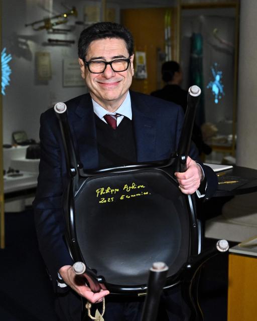 Laureate of The Sveriges Riksbank Prize in Economic Sciences 2025 French economist Philippe Aghion poses after signing a Nobel Chair at the Nobel Museum in Stockholm on December 6, 2025. (Photo by Claudio BRESCIANI / TT News Agency / AFP) / Sweden OUT
