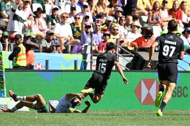 New Zealand's Jayden Keelan is tackled during the pool A HSBC World Rugby Sevens Series men's rugby match between New Zealand and South Africa at the DHL stadium in Cape Town on December 6, 2025. (Photo by Rodger Bosch / AFP)