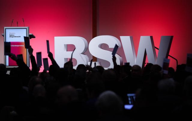 Delegates hold up voting cards during the federal party conference of left-wing populist Sahra Wagenknecht Alliance (BSW) in Magdeburg, eastern Germany on December 6, 2025. The party's 3rd federal congress takes place on December 6 and 7, 2025. (Photo by RONNY HARTMANN / AFP)