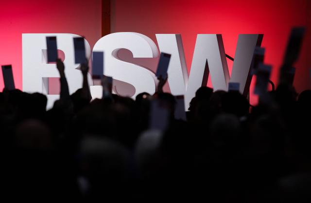 Delegates hold up voting cards during the federal party conference of left-wing populist Sahra Wagenknecht Alliance (BSW) in Magdeburg, eastern Germany on December 6, 2025. The party's 3rd federal congress takes place on December 6 and 7, 2025. (Photo by RONNY HARTMANN / AFP)