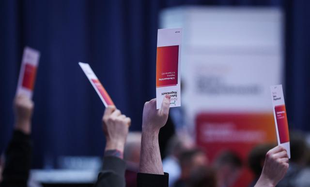 Delegates hold up voting cards during the federal party conference of left-wing populist Sahra Wagenknecht Alliance (BSW) in Magdeburg, eastern Germany on December 6, 2025. The party's 3rd federal congress takes place on December 6 and 7, 2025. (Photo by RONNY HARTMANN / AFP)