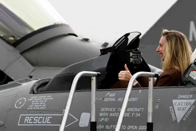 Argentina's General Secretary of the Presidency Karina Milei gives her thumb up from one of the six new F-16 Fighting Falcon planes during an official ceremony at the “Area de Material Rio IV" in Rio Cuarto, Cordoba province, Argentina on December 6, 2025. (Photo by Nicolas AGUILERA / AFP)