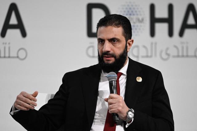 Syrian President Ahmed al-Sharaa speaks during the opening day of the Doha Forum, an annual diplomatic conference, in Doha on December 6, 2025. Sharaa warned on December 6 that Israel's demand for a demilitarised zone in southern Syria would endanger his country, as Israeli forces continue to operate in the area. (Photo by Mahmud HAMS / AFP)
