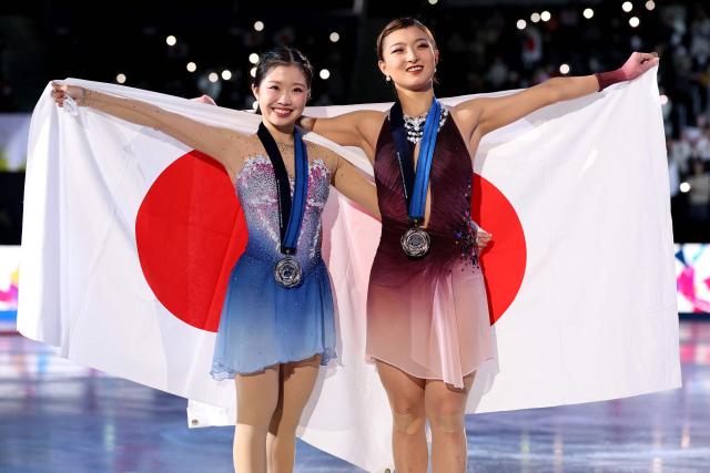 Silver medalist Japan's Kaori Sakamoto (L) poses with compatriot bronze medalist Ami Nakai after the award ceremony for the Senior Women Free Skating event at the ISU Grand Prix of Figure Skating final in Nagoya on December 6, 2025. (Photo by PAUL MILLER / AFP)