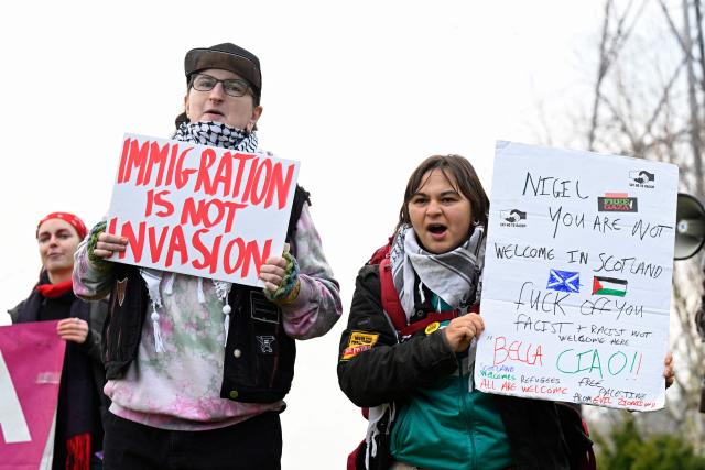Demonstrators protest against Reform UK's leader, Nigel Farage, near the venue of a rally being held by the political party, in Falkirk, Scotland, on December 6, 2025. Populist leader Nigel Farage rallied supporters in Scotland on Saturday, bidding to build on unexpectedly strong backing for his anti-immigration Reform UK party five months before elections to its devolved parliament. (Photo by Lesley Martin / AFP)