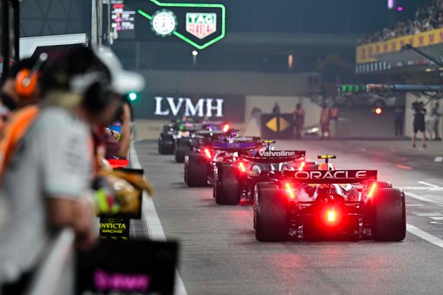 Cars line up in the pitlane during the qualifying session ahead of the Abu Dhabi Formula One Grand Prix at the Yas Marina Circuit in Abu Dhabi on December 6, 2025. (Photo by Giuseppe CACACE / POOL / AFP)