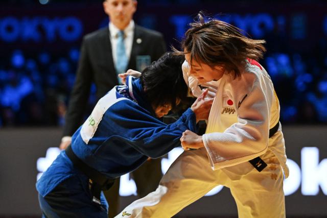 Japan's Uta Abe (R) and compatriot Nanako Tsubone compete in the women's under 52kg category gold medal match at the Tokyo Grand Slam judo competition in Tokyo on December 6, 2025. (Photo by Toshifumi KITAMURA / AFP)