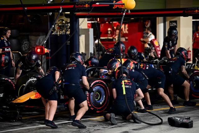 Mechanics work on Red Bull Racing's Dutch driver Max Verstappen's car during the qualifying session ahead of the Abu Dhabi Formula One Grand Prix at the Yas Marina Circuit in Abu Dhabi on December 6, 2025. (Photo by Giuseppe CACACE / POOL / AFP)
