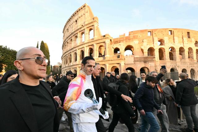 Italian singer Achille Lauro attends the Torch Relay to Milano Cortina 2026 Olympic Games, at the Colosseum in Rome on December 6, 2025. (Photo by Alberto PIZZOLI / AFP)