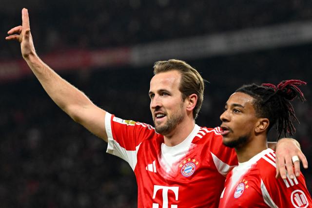 Bayern Munich's English forward #09 Harry Kane (L) celebrates with Bayern Munich's French midfielder #17 Michael Olise after scoring his side's 5th goal to complete his hat-trick during the German first division Bundesliga football match between VfB Stuttgart and Bayern Munich in Stuttgart on December 6, 2025. (Photo by THOMAS KIENZLE / AFP) / DFL REGULATIONS PROHIBIT ANY USE OF PHOTOGRAPHS AS IMAGE SEQUENCES AND/OR QUASI-VIDEO