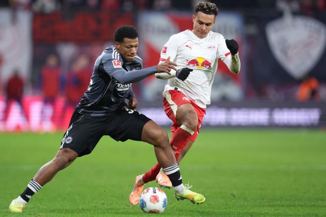 Frankfurt's German forward #32 Jessic Ngankam (L) and Leipzig's Norwegian forward #07 Antonio Nusa vie for the ball during the German first division Bundesliga football match between RB Leipzig and Eintracht Frankfurt in Leipzig, eastern Germany, on December 6, 2025. (Photo by Ronny HARTMANN / AFP) / DFL REGULATIONS PROHIBIT ANY USE OF PHOTOGRAPHS AS IMAGE SEQUENCES AND/OR QUASI-VIDEO