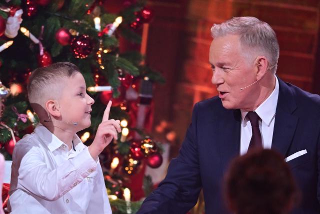 German TV host Johannes B. Kerner (R) speaks with cancer survivor Collin during the charity gala "Ein Herz Für Kinder" (A heart for children) in Berlin, on December 6, 2025. (Photo by Sebastian Gollnow / POOL / AFP)