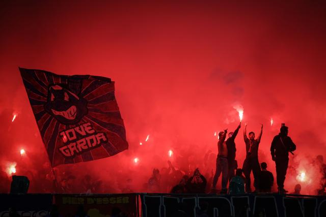 Toulouse's supporters light smoke bombs during the French L1 football match between Toulouse FC and RC Strasbourg Alsace at the TFC Stadium in Toulouse, southwestern France, on December 6, 2025. (Photo by Valentine CHAPUIS / AFP)