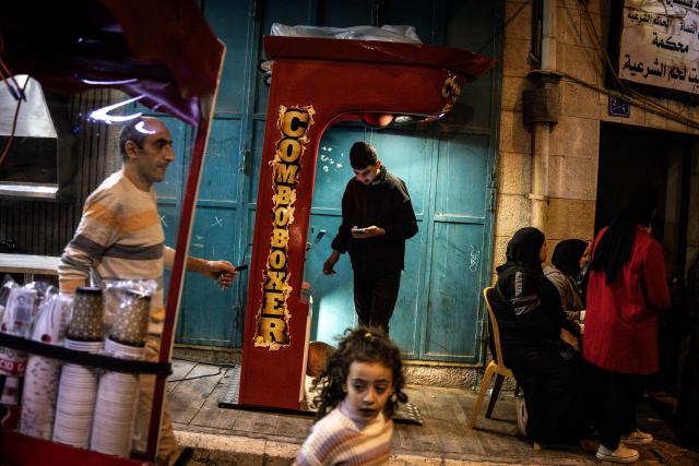 People gather in Nativity Square during a Christmas tree lighting ceremony in Bethlehem, in the Israeli-occupied West Bank, on December 6, 2025. (Photo by JOHN WESSELS / AFP)