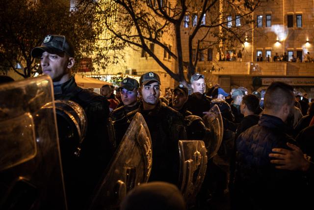 Police officers stand guard in Nativity Square during a Christmas tree lighting ceremony in Bethlehem, in the Israeli-occupied West Bank, on December 6, 2025. (Photo by JOHN WESSELS / AFP)