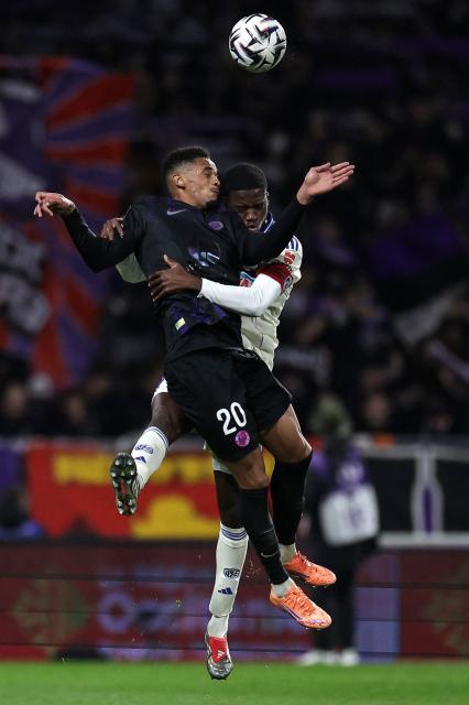 Toulouse's Brazilian forward #20 Emersonn (L) fights for the ball with Strasbourg's French defender #23 Mamadou Sarr (R) during the French L1 football match between Toulouse FC and RC Strasbourg Alsace at the TFC Stadium in Toulouse, southwestern France, on December 6, 2025. (Photo by Valentine CHAPUIS / AFP)
