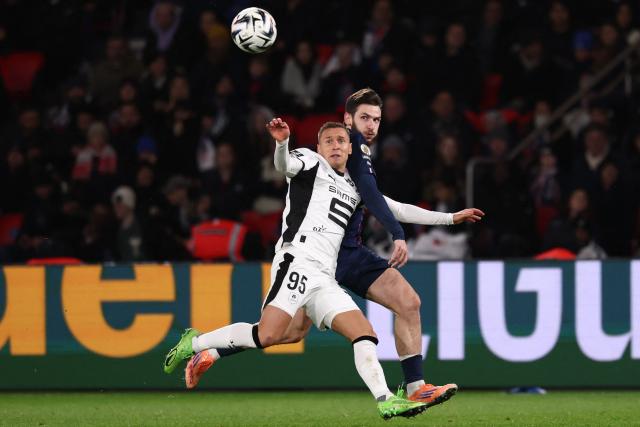 Rennes' Polish defender #95 Przemyslaw Frankowski (L) fights for the ball with Paris Saint-Germain's Georgian forward #07 Khvicha Kvaratskhelia during the French L1 football match between Paris Saint-Germain (PSG) and Stade Rennais FC at the Parc des Princes stadium in Paris on December 6, 2025. (Photo by FRANCK FIFE / AFP)
