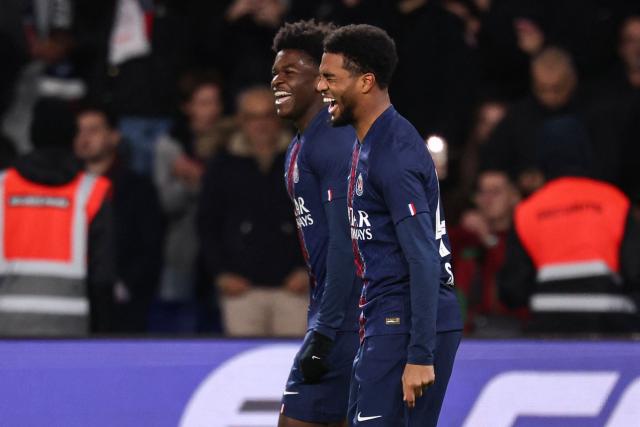 Paris Saint-Germain's French forward #49 Ibrahim Mbaye (R) celebrates scoring his team's fourth goal during the French L1 football match between Paris Saint-Germain (PSG) and Stade Rennais FC at the Parc des Princes stadium in Paris on December 6, 2025. (Photo by FRANCK FIFE / AFP)