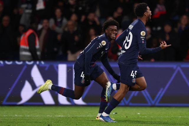 Paris Saint-Germain's French forward #49 Ibrahim Mbaye (R) celebrates scoring his team's fourth goal during the French L1 football match between Paris Saint-Germain (PSG) and Stade Rennais FC at the Parc des Princes stadium in Paris on December 6, 2025. (Photo by FRANCK FIFE / AFP)