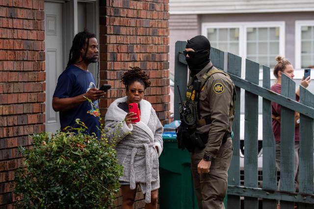 Residents watch as US Customs and Border Patrol Commander Gregory Bovino and fellow agents conduct operations in Kenner, Louisiana, on December 6, 2025. The US Department of Homeland Security announced on December 3 it has launched a federal immigration enforcement operation, named "Operation Catahoula Crunch," in the New Orleans, Louisiana, area. (Photo by Adam GRAY / AFP)