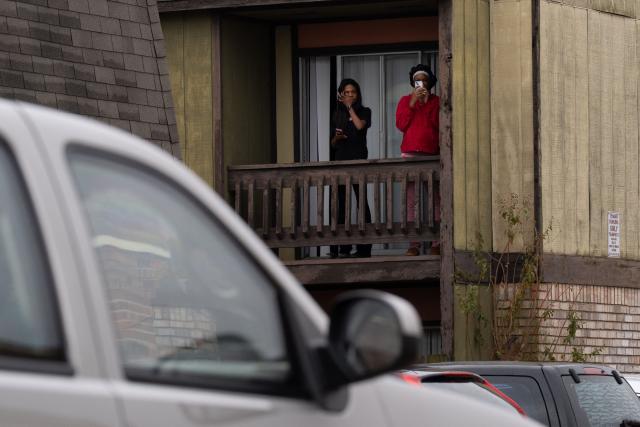A resident shouts on a megaphone as US Customs and Border agents conduct operations in Kenner, Louisiana, on December 6, 2025. The US Department of Homeland Security announced on December 3 it has launched a federal immigration enforcement operation, named "Operation Catahoula Crunch," in the New Orleans, Louisiana, area. (Photo by Adam GRAY / AFP)