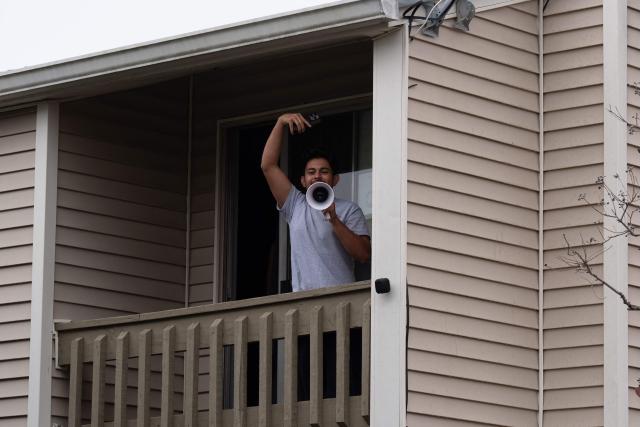 A resident shouts on a megaphone as US Customs and Border agents conduct operations in Kenner, Louisiana, on December 6, 2025. The US Department of Homeland Security announced on December 3 it has launched a federal immigration enforcement operation, named "Operation Catahoula Crunch," in the New Orleans, Louisiana, area. (Photo by Adam GRAY / AFP)