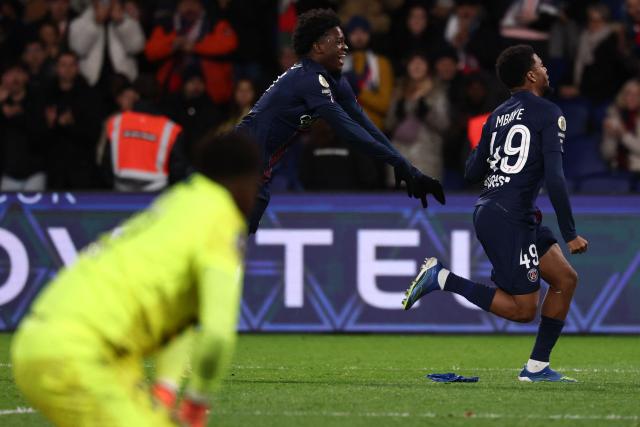 Paris Saint-Germain's French forward #49 Ibrahim Mbaye (R) celebrates scoring his team's fourth goal during the French L1 football match between Paris Saint-Germain (PSG) and Stade Rennais FC at the Parc des Princes stadium in Paris on December 6, 2025. (Photo by FRANCK FIFE / AFP)