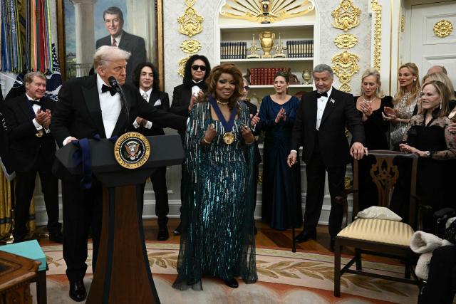 Kennedy Centre Honours recipient singer Gloria Gaynor receives a medal from US President Donald Trump during the Kennedy Centre Honours medal presentation ahead of tomorrow's ceremony, in the Oval Office of the White House in Washington, DC, December 6, 2025. (Photo by Brendan SMIALOWSKI / AFP)