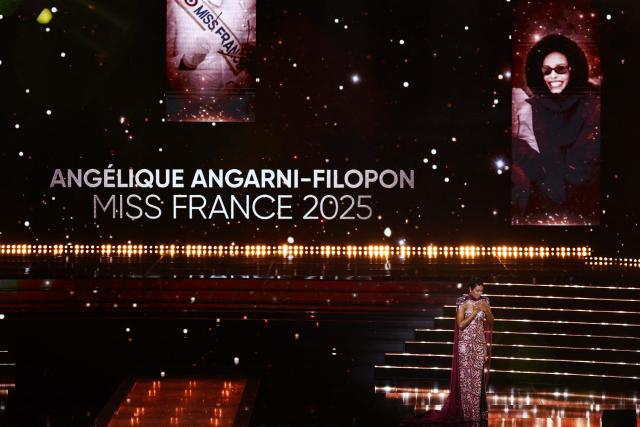 Miss France 2025 Angelique Angarni-Filopon reacts on stage during the Miss France 2026 beauty pageant at the Zenith, in Amiens, northern France, on December 6, 2025. (Photo by Sameer AL-DOUMY / AFP)