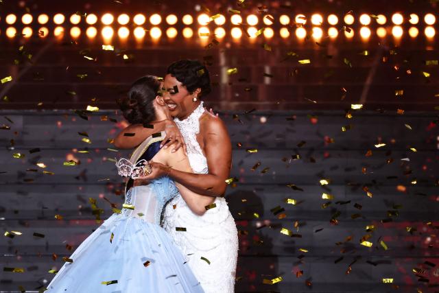 Miss Tahiti Hinaupoko Deveze (L) celebrates before being crowned by Miss France 2025 Angelique Angarni-Filopon during the Miss France 2026 beauty pageant at the Zenith, in Amiens, northern France, on December 6, 2025. (Photo by Sameer AL-DOUMY / AFP)