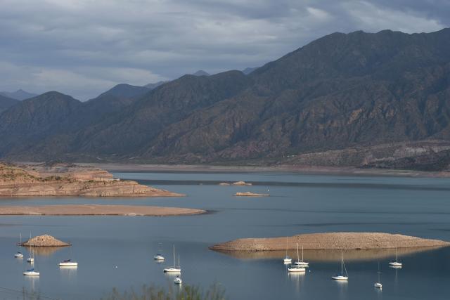 This view shows sailboats on the Potrerillos Reservoir, located 60 km from Mendoza City, Argentina, on December 6, 2025. (Photo by Andres Larrovere / AFP)