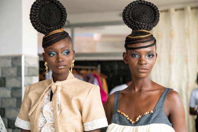 Models pose for backstage photos before the final show of the Dakar Fashion Week, which takes place aboard pirogues, in Ngor Bay, Dakar, Senegal, on December 6, 2025. (Photo by NICOLAS REMENE / AFP)