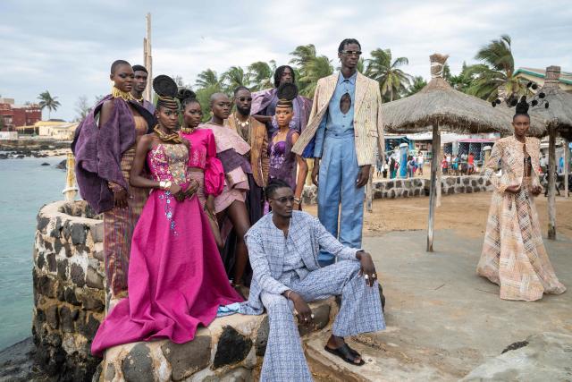Models pose before the final show of Dakar Fashion Week, which takes place aboard pirogues in Ngor Bay, Dakar, Senegal, on December 6, 2025. (Photo by NICOLAS REMENE / AFP)