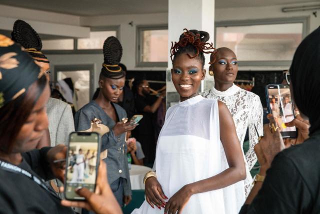 Models pose for for backstage photos before the final show of the Dakar Fashion Week, which takes place aboard pirogues, in Ngor Bay, Dakar, Senegal, on December 6, 2025. (Photo by NICOLAS REMENE / AFP)