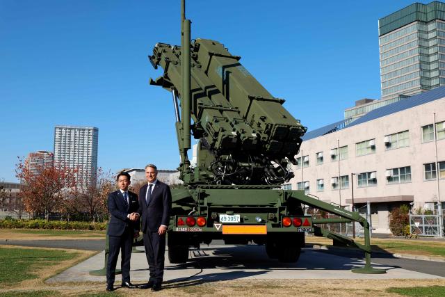 Japanese Defence Minister Shinjiro Koizumi (L) poses with Australian Defence Minister Richard Marles in front of a Patriot Advanced Capability-3 (PAC-3) missile interceptor unit at the Defense Ministry in Tokyo on December 7, 2025. (Photo by Franck ROBICHON / POOL / AFP)