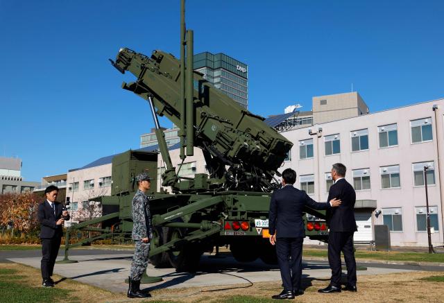Japanese Defence Minister Shinjiro Koizumi (2nd R) and Australian Defence Minister Richard Marles (R) inspect a Patriot Advanced Capability-3 (PAC-3) missile interceptor unit at the Defense Ministry in Tokyo on December 7, 2025. (Photo by Franck ROBICHON / POOL / AFP)