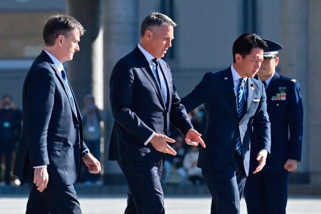 Japan’s Defence Minister Shinjiro Koizumi (R) walks with Australia’s Defence Minister Richard Marles (2nd L) during a welcome ceremony at the Ministry of Defense in Tokyo on December 7, 2025. (Photo by David Mareuil / POOL / AFP)