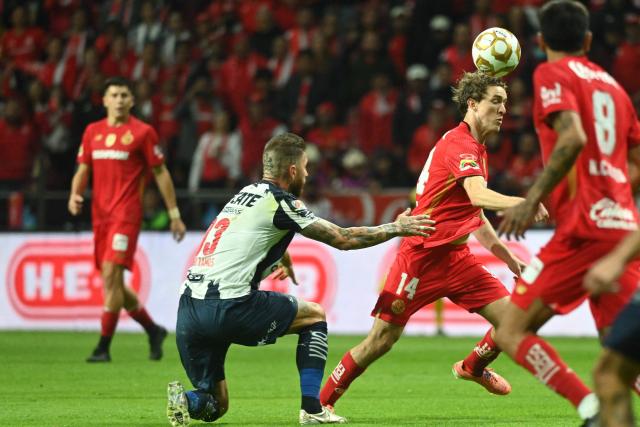 Monterrey's Spanish defender #93 Sergio Ramos and Toluca's midfielder #14 Marcel Ruiz fight for the ball during the Liga MX Apertura semifinal second leg football match between Toluca and Monterrey at the Nemesio Diez stadium in Toluca de Lerdo, Mexico on December 6, 2025. (Photo by Mario Vazquez / AFP)