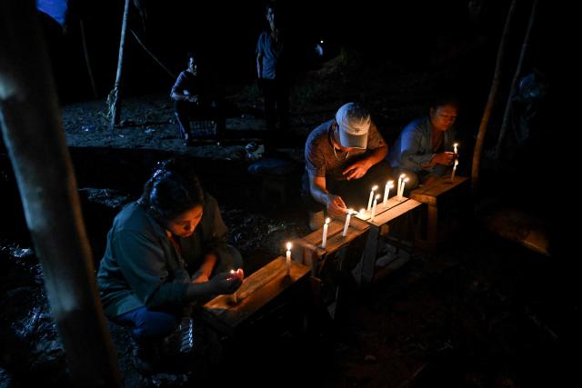 Relatives of the victims hold a vigil following a boat accident at the port of Iparia, in the Ucayali department of Peru’s central jungle, on December 6, 2025. At least 12 people, including three children, died on December 1, 2025, when a landslide sank two boats docked at a river port in central Peru, with dozens of others missing, officials said. (Photo by Hugo Alejos / AFP)