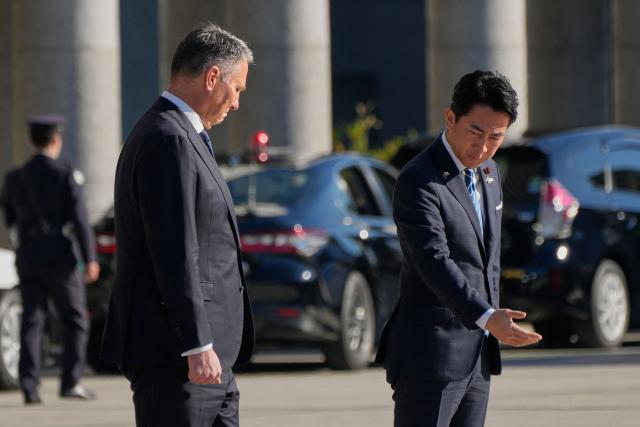 Japan’s Defence Minister Shinjiro Koizumi (R) gestures to Australia’s Defence Minister Richard Marles during a welcome ceremony at the Ministry of Defense in Tokyo on December 7, 2025. (Photo by Eugene Hoshiko / POOL / AFP)
