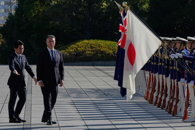 Japan’s Defence Minister Shinjiro Koizumi (L) and Australia’s Defence Minister Richard Marles review honour guards during a welcome ceremony at the Ministry of Defense in Tokyo on December 7, 2025. (Photo by Eugene Hoshiko / POOL / AFP)