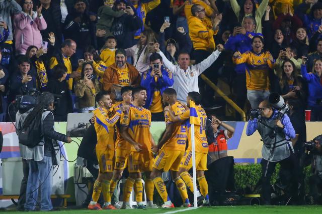 Tigres' Argentine midfielder #11 Juan Brunetta (C) celebrates with teammates after scoring his team’s first goal during the Liga MX Apertura semifinal second leg football match between Tigres and Cruz Azul at the UANL University Stadium in San Nicolas de los Garza, Nuevo Leon State, Mexico on December 6, 2025. (Photo by Julio Cesar AGUILAR / AFP)