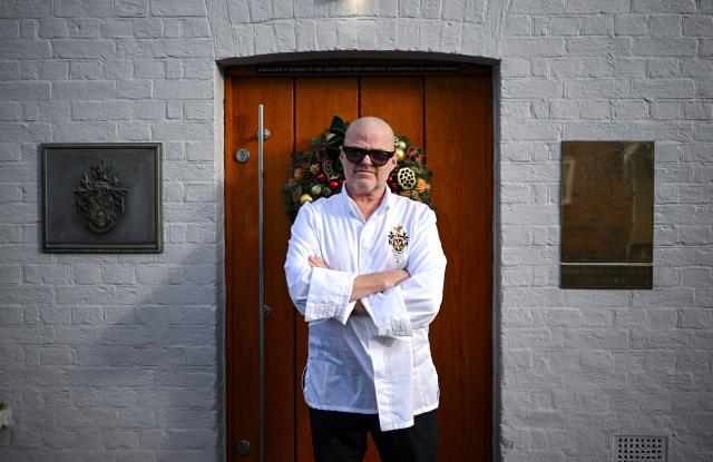 Chef Heston Blumenthal poses for a portrait outside The Fat Duck restaurant in Bray, west of London, on November 19, 2025. When Michelin-starred UK chef Heston Blumenthal turned to skinny jabs to lose weight, his appetite evaporated and he realised the popularity of such medications risked biting into restaurant sales. So he devised a menu-lite, offering small plates of his star menu "The Journey", at his Fat Duck restaurant in the village of Bray, west of London. (Photo by JUSTIN TALLIS / AFP) / TO GO WITH AFP STORY By Caroline TAIX