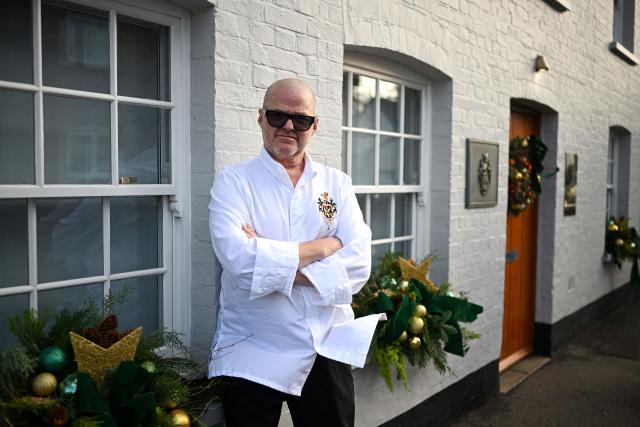 Chef Heston Blumenthal poses for a portrait outside The Fat Duck restaurant in Bray, west of London, on November 19, 2025. When Michelin-starred UK chef Heston Blumenthal turned to skinny jabs to lose weight, his appetite evaporated and he realised the popularity of such medications risked biting into restaurant sales. So he devised a menu-lite, offering small plates of his star menu "The Journey", at his Fat Duck restaurant in the village of Bray, west of London. (Photo by JUSTIN TALLIS / AFP) / TO GO WITH AFP STORY By Caroline TAIX