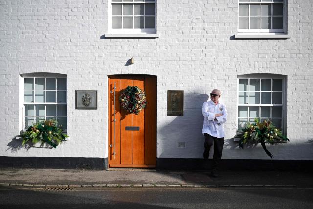 Chef Heston Blumenthal poses for a portrait outside The Fat Duck restaurant in Bray, west of London, on November 19, 2025. When Michelin-starred UK chef Heston Blumenthal turned to skinny jabs to lose weight, his appetite evaporated and he realised the popularity of such medications risked biting into restaurant sales. So he devised a menu-lite, offering small plates of his star menu "The Journey", at his Fat Duck restaurant in the village of Bray, west of London. (Photo by JUSTIN TALLIS / AFP) / TO GO WITH AFP STORY By Caroline TAIX