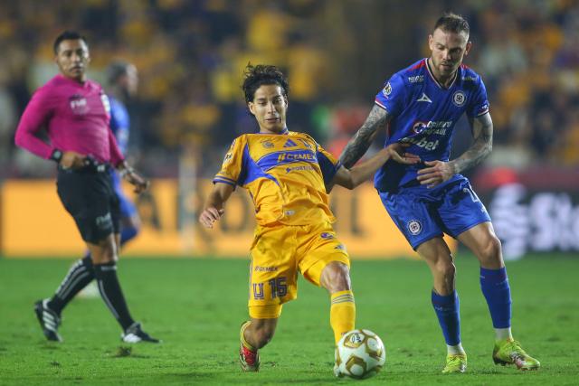 Tigres' midfielder #16 Diego Lainez and Cruz Azul's Argentine forward #29 Rodolfo Rotondi fight for the ball during the Liga MX Apertura semifinal second leg football match between Tigres and Cruz Azul at the UANL University Stadium in San Nicolas de los Garza, Nuevo Leon State, Mexico on December 6, 2025. (Photo by Julio Cesar AGUILAR / AFP)