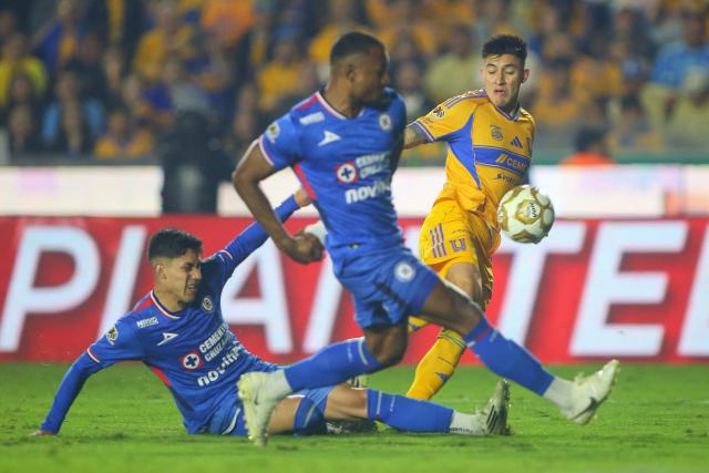 Tigres' US defender #03 Marco Farfan and Cruz Azul's defender #03 Omar Campos (C) fight for the ball during the Liga MX Apertura semifinal second leg football match between Tigres and Cruz Azul at the UANL University Stadium in San Nicolas de los Garza, Nuevo Leon State, Mexico on December 6, 2025. (Photo by Julio Cesar AGUILAR / AFP)