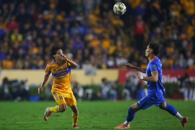 Tigres' midfielder #16 Diego Lainez and Cruz Azul's defender #05 Jesus Orozco fight for the ball during the Liga MX Apertura semifinal second leg football match between Tigres and Cruz Azul at the UANL University Stadium in San Nicolas de los Garza, Nuevo Leon State, Mexico on December 6, 2025. (Photo by Julio Cesar AGUILAR / AFP)