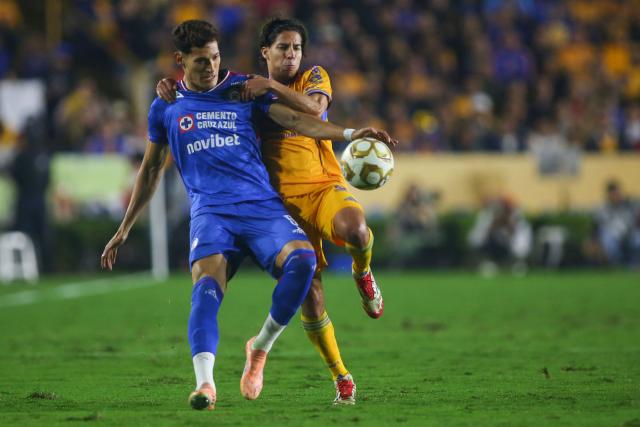 Cruz Azul's defender #05 Jesus Orozco and Tigres' midfielder #16 Diego Lainez fight for the ball during the Liga MX Apertura semifinal second leg football match between Tigres and Cruz Azul at the UANL University Stadium in San Nicolas de los Garza, Nuevo Leon State, Mexico on December 6, 2025. (Photo by Julio Cesar AGUILAR / AFP)